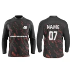 Black custom ice hockey jersey with red abstract patterns by Adrees Enterprises.